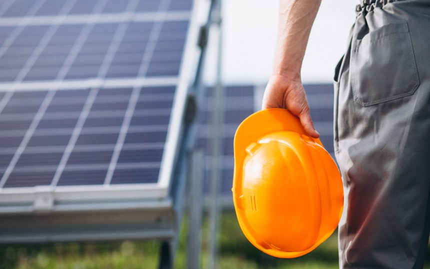 Man worker in the firld by the solar panels Solar Power Installation Haiti